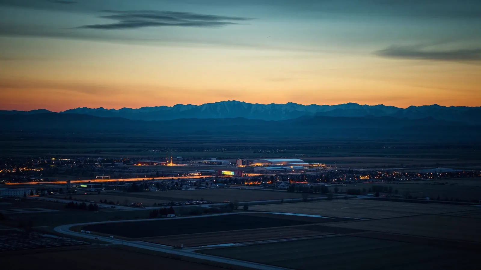 Northern Colorado plains city with farmland and the Rocky Mountains on the horizon